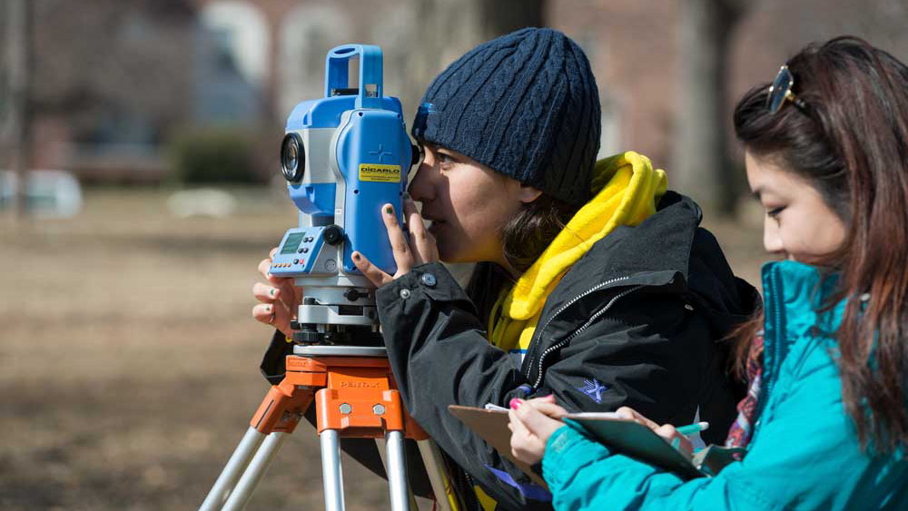 students using surveying equipment