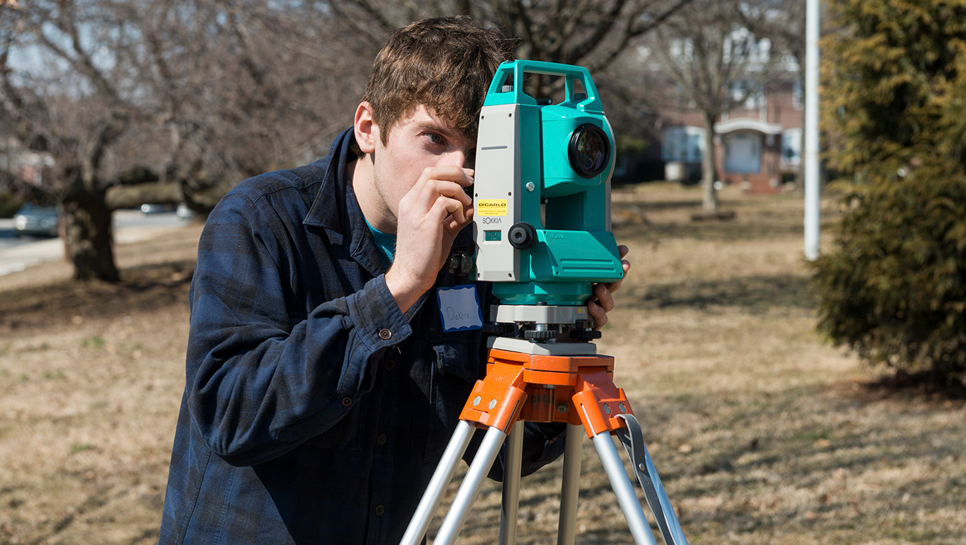 students using surveying equipment