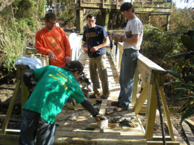 Civil Engineering students working on wooden bridge